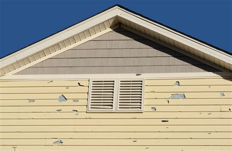 repair damaged siding on house